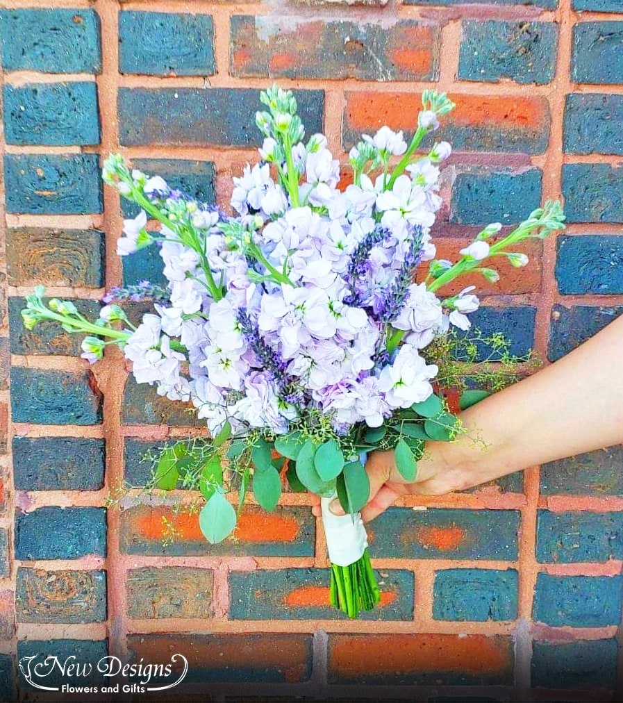 A stunning bouquet of Lavender Stock with wheat stems spiking through